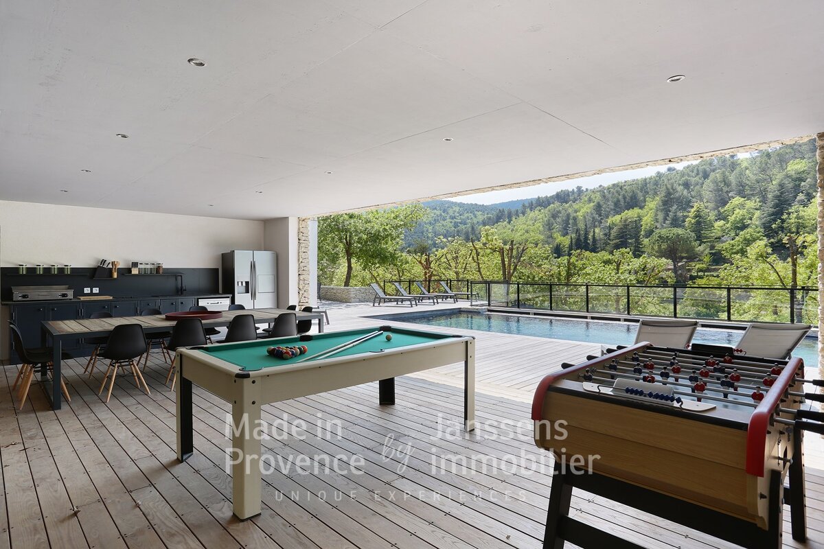 A pool table and foosball table on a deck made in provence