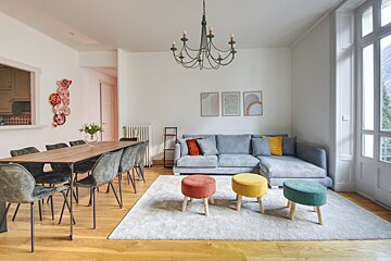 A living room with a couch a table and chairs