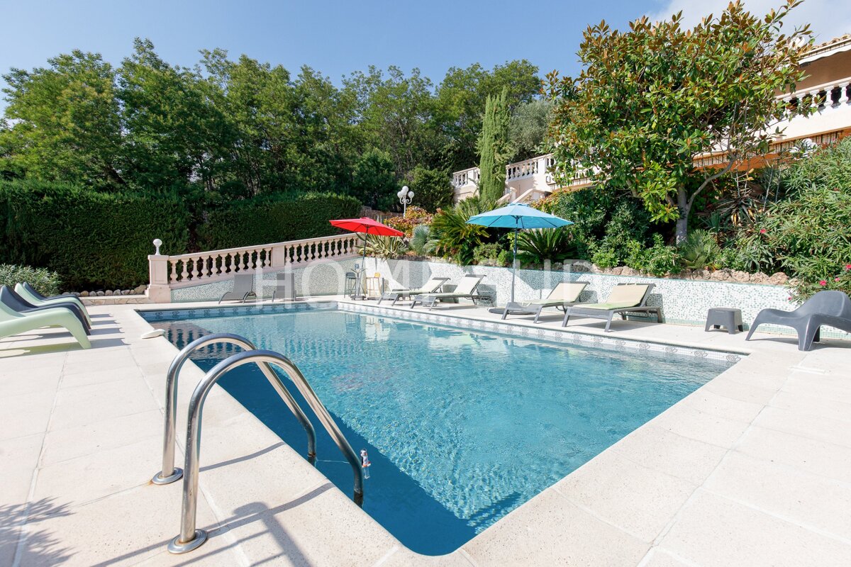 A large swimming pool is surrounded by chairs and umbrellas and a sign that says horizons