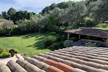 A rooftop view of a lush green backyard