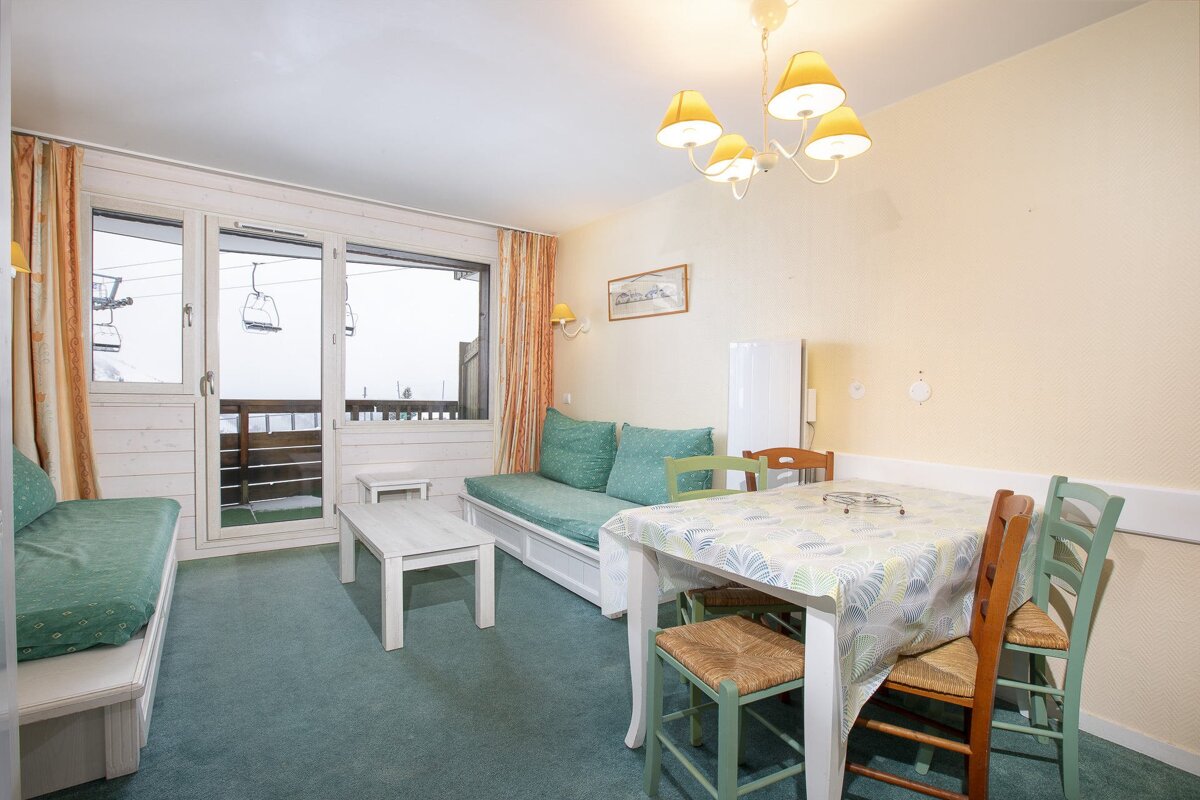 A living room with a dining table and chairs