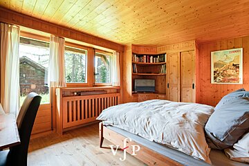 A bedroom with a poster on the wall that says zegnamatt