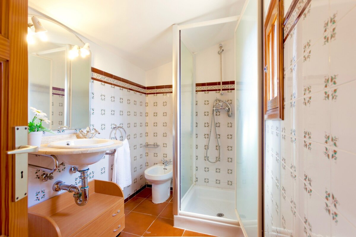 A bathroom with a sink and a walk in shower