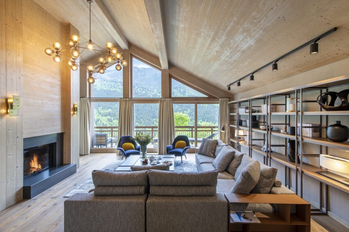A living room with a couch and chairs and a fireplace