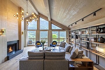 A living room with a couch and chairs and a fireplace