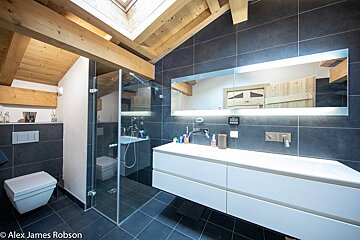 A bathroom with a toilet sink and mirror by alex james robson