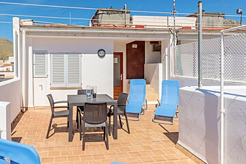 A balcony with a table and chairs on it