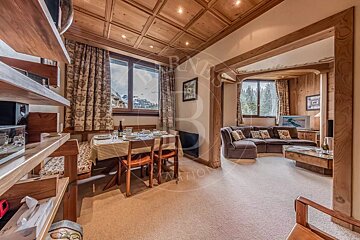 A living room with a couch a table and chairs and the word nation on the wall