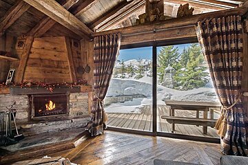 A living room with a fireplace and a sliding glass door