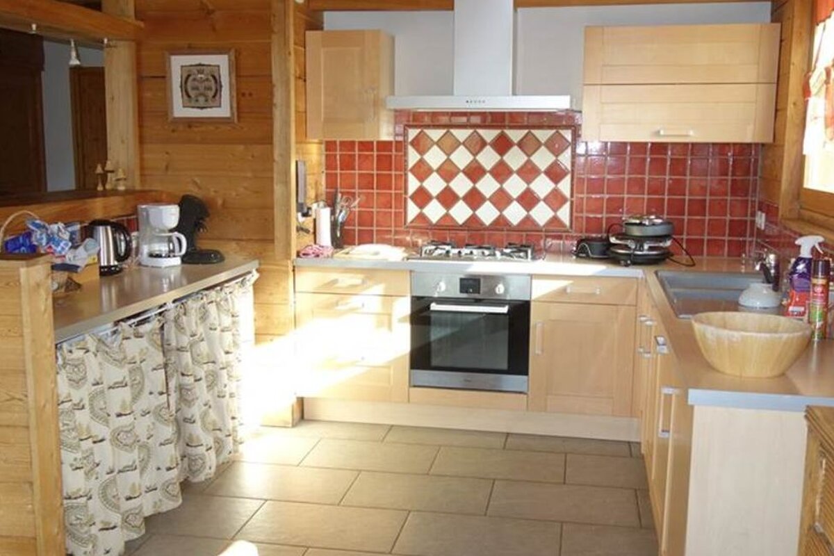 A kitchen with stainless steel appliances and wooden cabinets