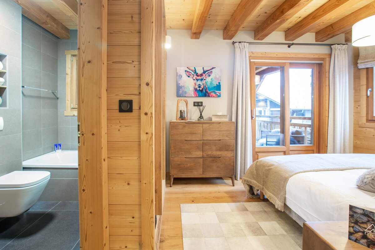 A bedroom with a painting of a deer on the wall