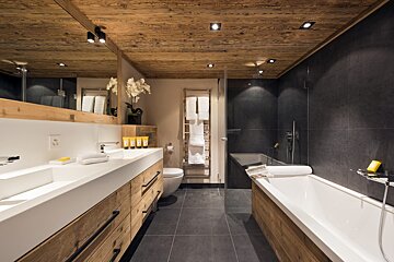 A bathroom with a bathtub and two sinks