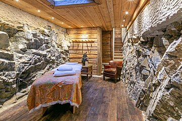 A massage table in a room with a skylight above it