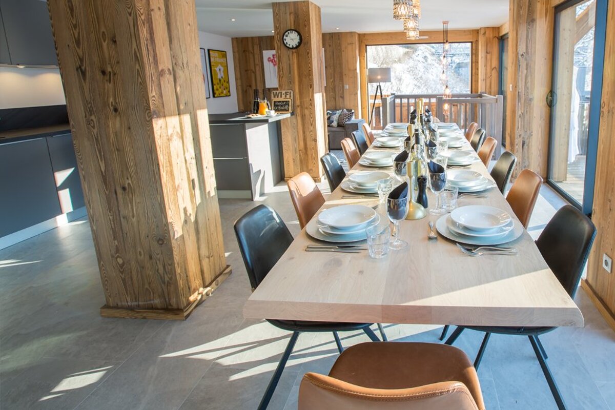 A dining room with a table and chairs and a sign that says wi-fi