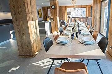 A dining room with a table and chairs and a sign that says wi-fi