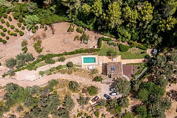 An aerial view of a house with a swimming pool