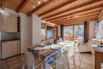 A kitchen and dining area with a map of the world on the wall