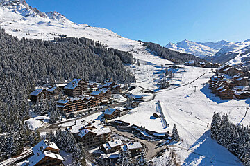 An aerial view of a ski resort in the mountains