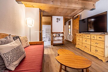 A living room with a couch and a flat screen tv