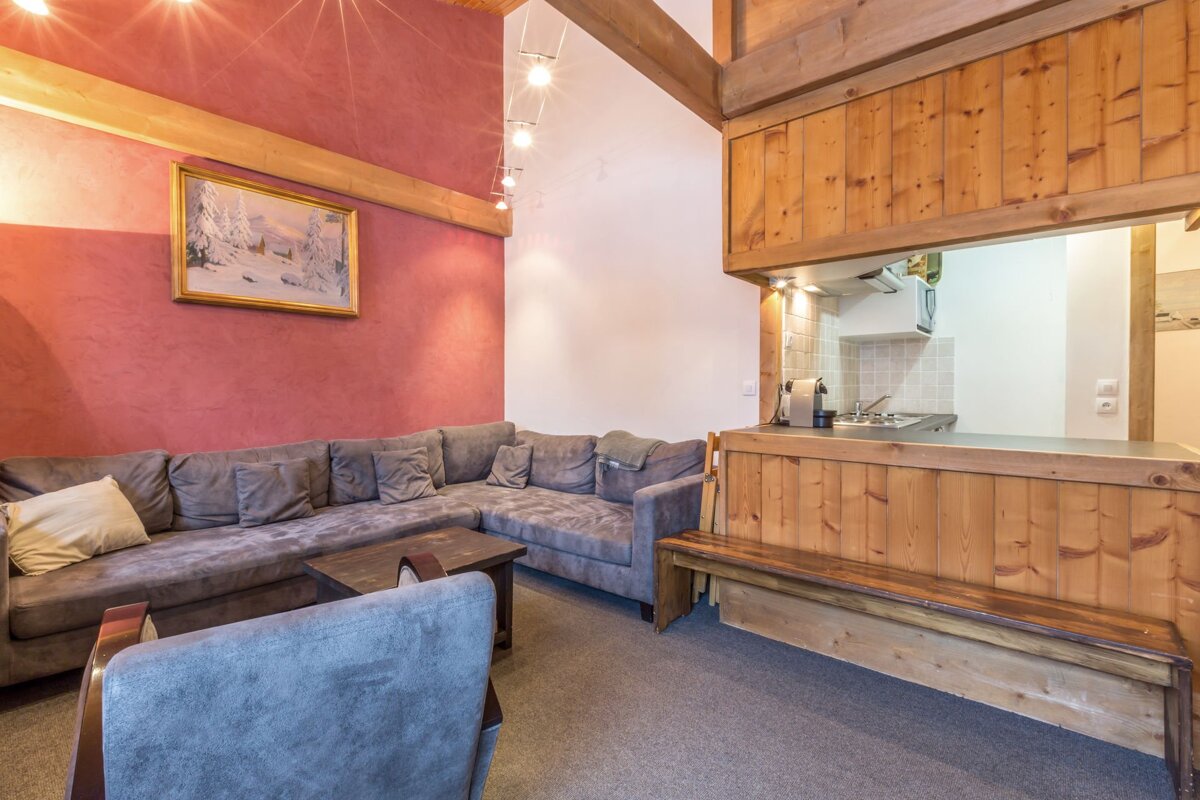 A living room with a table and chairs and stairs