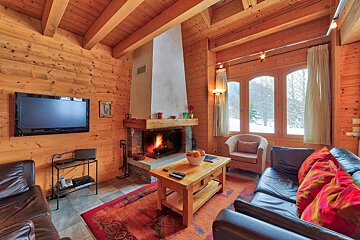 A living room with a fireplace and a flat screen tv