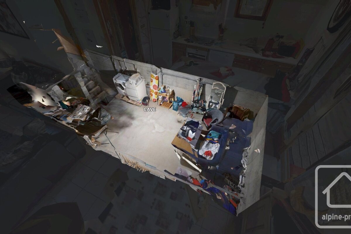 A 3D scan of a messy basement utility room with a washer, ironing board, shelves, and boxes of clothes. 