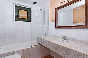 A bathroom with a sink a toilet and a shower