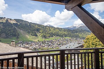 A balcony with a view of a valley and mountains taken by alex james robson