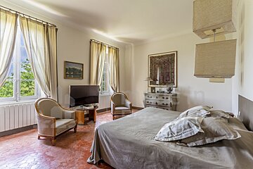 A bedroom with a large bed and a flat screen tv