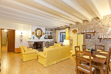 A living room with yellow furniture and a fireplace