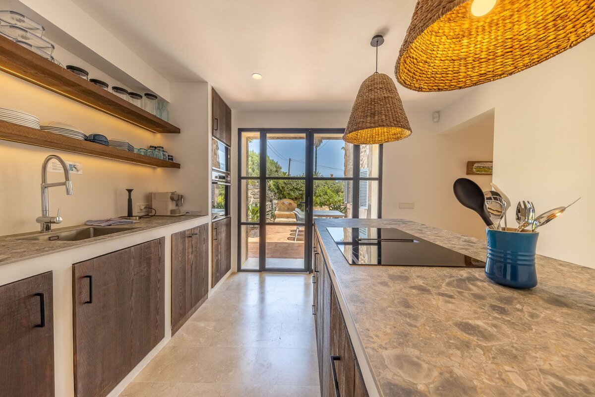 A kitchen with wooden cabinets and a stove top oven