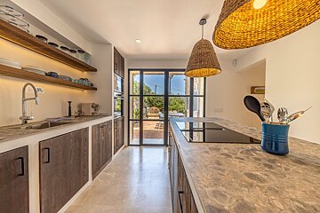 A kitchen with wooden cabinets and a stove top oven