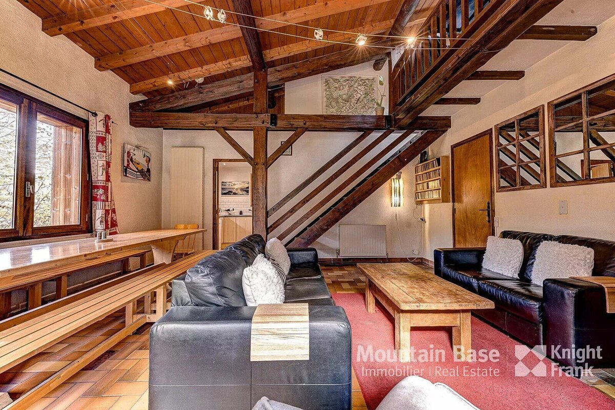 A living room with a couch and a table with the words mountain base on the bottom