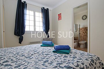 A bedroom with blue curtains and a bed that says home sud