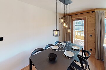 A dining room table with plates and glasses on it