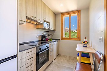 A kitchen with a table and chairs and a window