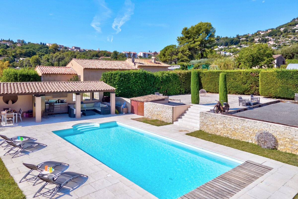 A large swimming pool in the backyard of a house