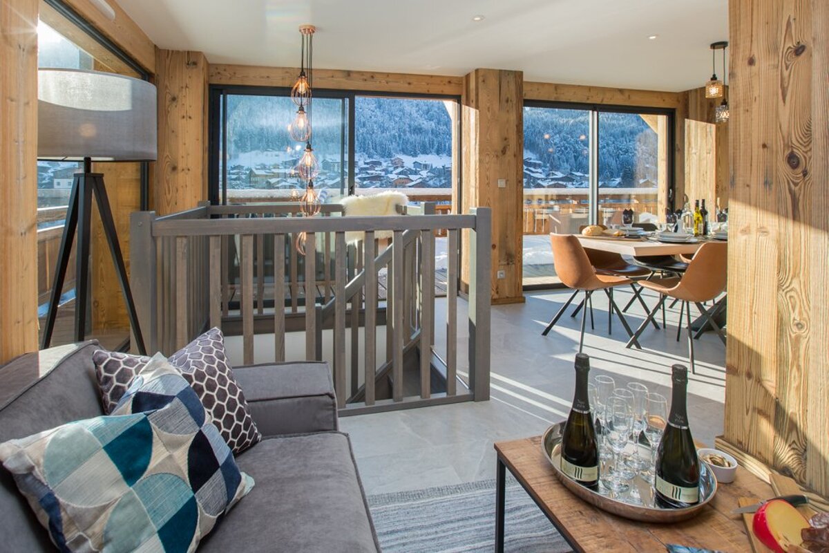 A living room with a couch and a table with bottles of champagne on it