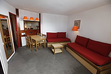 A living room with a couch a table and chairs
