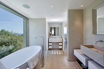 A bathroom with two sinks and a large window