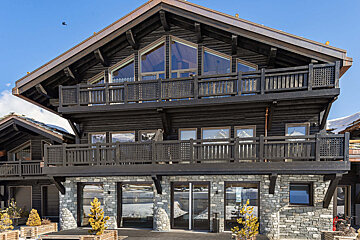 A large house with a lot of windows and balconies