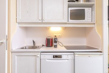 A small kitchen with a microwave and a dishwasher