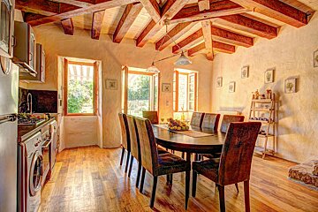 A kitchen with a table and chairs in it