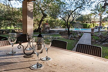 A table with wine glasses and a bottle of wine on it
