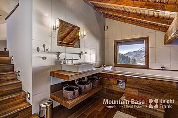 A bathroom with a sink and a tub and the words mountain base knight frank on the bottom