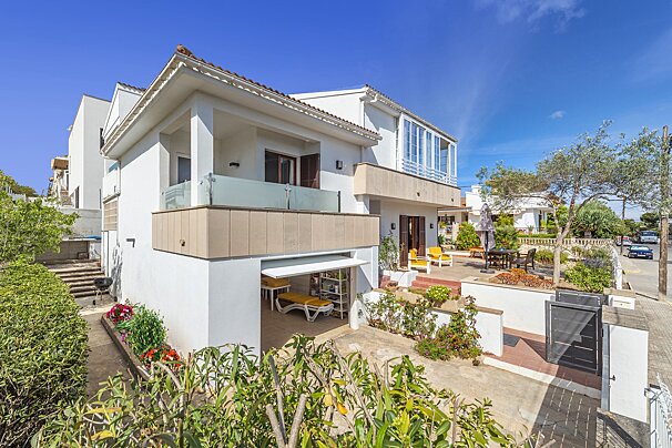 A large white house with a large balcony