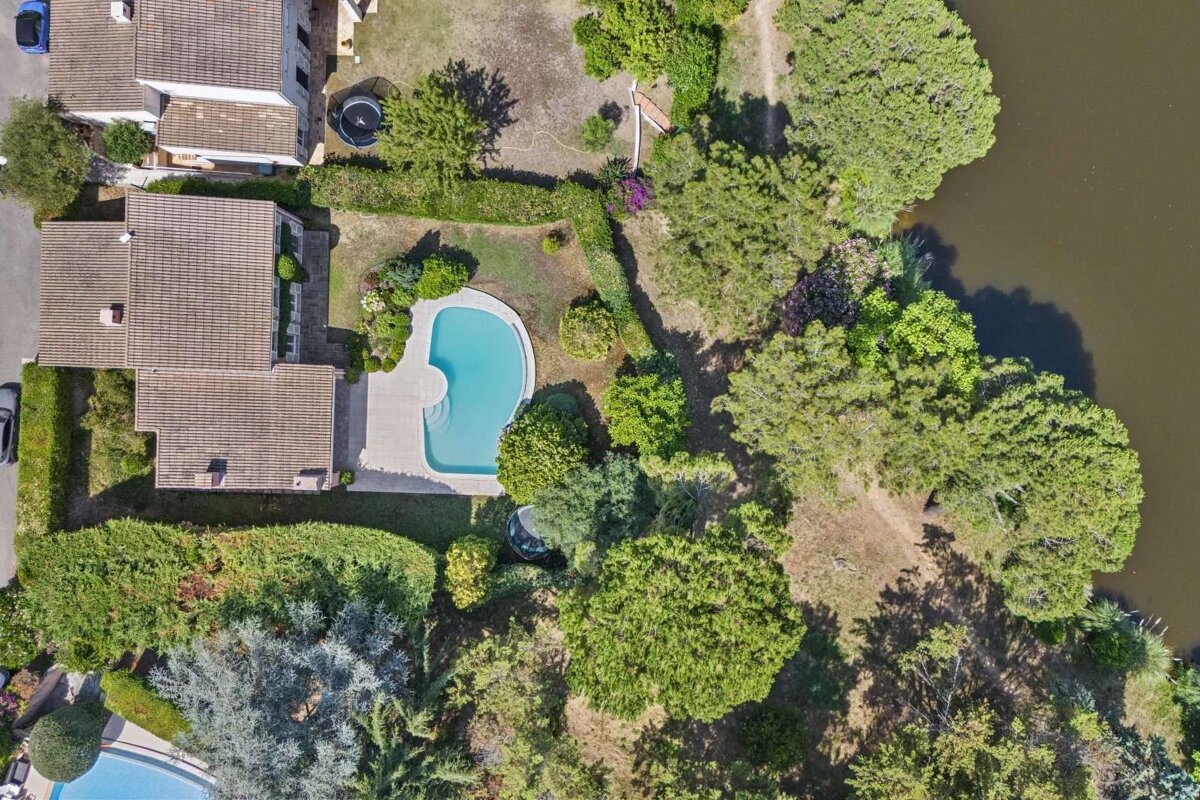 An aerial view of a house with a swimming pool