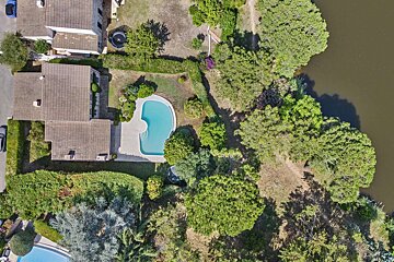 An aerial view of a house with a swimming pool