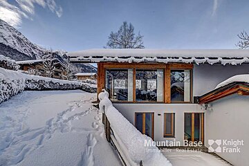 A snowy house with knight frank written on the side
