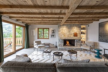 A living room with a stone fireplace and a couch